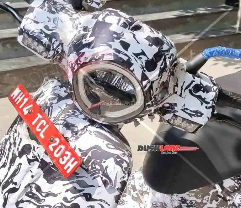 नवीन बजाज चेतकचे स्पाय शॉट्स हँडलबारवर इंडिकेटर्स, फ्लॅट सीट आणि अपडेटेड इन्स्ट्रुमेंट क्लस्टर स्पष्ट दिसत आहे.﻿